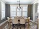Elegant dining room with modern chandelier, large windows, and stylish furnishings at 397 Luray Way, Rock Hill, SC 29730