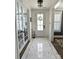Bright foyer featuring elegant tile flooring, a decorative wreath on the front door, and white trim at 397 Luray Way, Rock Hill, SC 29730