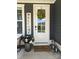A charming front door features a decorative wreath, a welcome sign, and stylish lanterns at 397 Luray Way, Rock Hill, SC 29730