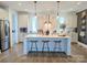 Bright, open kitchen with white cabinets, stainless steel appliances, and large center island with seating at 397 Luray Way, Rock Hill, SC 29730