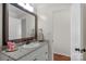 Bright bathroom featuring granite vanity, framed mirror, and white cabinets at 4072 Town Center Rd, Harrisburg, NC 28075