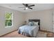 Bedroom with wood floors, ceiling fan, and natural light from a window at 4072 Town Center Rd, Harrisburg, NC 28075