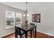 Bright dining area with hardwood floors, natural light, and modern chandelier at 4072 Town Center Rd, Harrisburg, NC 28075