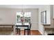 Cozy dining area with bright windows, hardwood floors, and modern chandelier at 4072 Town Center Rd, Harrisburg, NC 28075