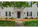 Charming building entrance featuring a covered porch and well-maintained landscaping at 4072 Town Center Rd, Harrisburg, NC 28075