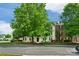 Building exterior highlighting well-kept landscaping, mature trees, and inviting entrance at 4072 Town Center Rd, Harrisburg, NC 28075