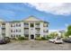 Apartment building showcasing multiple balconies and manicured bushes, creating a warm, inviting atmosphere at 4072 Town Center Rd, Harrisburg, NC 28075