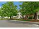 Exterior view of the building showcasing its curb appeal and mature landscaping at 4072 Town Center Rd, Harrisburg, NC 28075