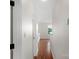 Hallway leading to bedroom and kitchen area with hardwood flooring at 4072 Town Center Rd, Harrisburg, NC 28075