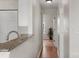 Hallway featuring wood flooring and a view into the kitchen area at 4072 Town Center Rd, Harrisburg, NC 28075
