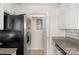 Kitchen showing stainless steel refrigerator and granite countertops at 4072 Town Center Rd, Harrisburg, NC 28075