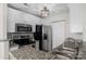 Bright kitchen featuring stainless steel appliances, granite countertops, and white cabinets at 4072 Town Center Rd, Harrisburg, NC 28075