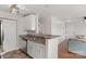 Charming kitchenette features white cabinetry, stainless steel dishwasher and tile floors at 4072 Town Center Rd, Harrisburg, NC 28075