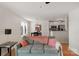 Comfortable living room with gray sofa, pink accents, and view into kitchen area at 4072 Town Center Rd, Harrisburg, NC 28075