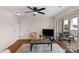 Bright living room featuring balcony access, ceiling fan, and stylish furnishings at 4072 Town Center Rd, Harrisburg, NC 28075