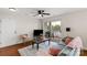 Relaxing living room with balcony access, ceiling fan, and comfortable seating at 4072 Town Center Rd, Harrisburg, NC 28075