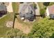 Aerial view of a home highlighting a large backyard, brick patio, outdoor seating, and fire pit at 4117 Wallbrook Dr, Matthews, NC 28105