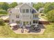 Gorgeous backyard featuring an expansive brick patio, outdoor seating, and lush greenery at 4117 Wallbrook Dr, Matthews, NC 28105