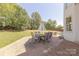Backyard brick patio with an umbrella-covered dining table, ideal for enjoying meals outdoors at 4117 Wallbrook Dr, Matthews, NC 28105