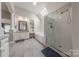 Bathroom featuring a soaking tub, glass enclosed shower, skylight, and tile flooring at 4117 Wallbrook Dr, Matthews, NC 28105