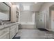 Bathroom featuring a soaking tub, glass enclosed shower, skylight, and granite countertops at 4117 Wallbrook Dr, Matthews, NC 28105