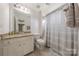 Neutral bathroom features a granite countertop vanity and a tiled shower and flooring at 4117 Wallbrook Dr, Matthews, NC 28105