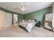 This bedroom offers soft carpet, a ceiling fan, and access to an en-suite bathroom at 4117 Wallbrook Dr, Matthews, NC 28105