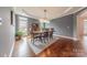 Formal dining room featuring hardwood floors, tray ceiling, and ample natural light at 4117 Wallbrook Dr, Matthews, NC 28105