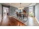 Elegant dining room with hardwood floors, modern lighting, and large window at 4117 Wallbrook Dr, Matthews, NC 28105