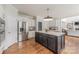Open kitchen featuring an island, stainless steel refrigerator and ample cabinet space at 4117 Wallbrook Dr, Matthews, NC 28105