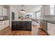 Open-concept kitchen with an island, hardwood floors, and a view to the living room at 4117 Wallbrook Dr, Matthews, NC 28105