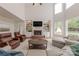 Spacious living room with a brick fireplace, built-in shelving, and lots of natural light at 4117 Wallbrook Dr, Matthews, NC 28105
