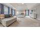 Bright main bedroom showcasing neutral tones, comfortable sitting area, and a large decorative bed at 4117 Wallbrook Dr, Matthews, NC 28105