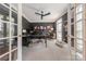 Cozy office with a ceiling fan, custom shelving and ample workspace, featuring a dog bed at 4117 Wallbrook Dr, Matthews, NC 28105