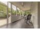 Relaxing sunroom featuring tile floors, a ceiling fan, and screened windows for insect-free enjoyment at 4117 Wallbrook Dr, Matthews, NC 28105