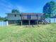 A spacious backyard featuring a wooden deck, green lawn, and a privacy fence at 412 Brook St, Salisbury, NC 28146