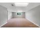 Bright basement featuring carpeted floors, neutral tones, and natural light from the window at 412 Brook St, Salisbury, NC 28146