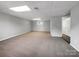 Bright basement featuring carpeted floors, neutral tones, and natural light from the window at 412 Brook St, Salisbury, NC 28146