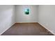 Small bedroom with a neutral color palette, a single window and plush carpeting at 412 Brook St, Salisbury, NC 28146