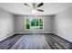 A spacious, bright bedroom featuring hardwood floors, a ceiling fan, and a large window at 412 Brook St, Salisbury, NC 28146