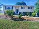 Charming two-story home featuring a landscaped front yard with a walkway leading to the front door at 412 Brook St, Salisbury, NC 28146