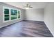 Spacious living room featuring hardwood floors, large windows, and modern ceiling fan at 412 Brook St, Salisbury, NC 28146