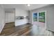 Open-concept living and dining area features hardwood-style floors and sliding doors to a deck at 412 Brook St, Salisbury, NC 28146