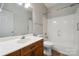 Clean bathroom featuring a tub and shower combination, white countertops, and a wood vanity at 4161 Deerfield Dr, Concord, NC 28027