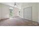 Spacious bedroom with carpet, natural light from arched windows, ceiling fan and large closet at 4161 Deerfield Dr, Concord, NC 28027