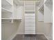 Organized walk-in closet featuring built-in shelving and drawers at 4161 Deerfield Dr, Concord, NC 28027