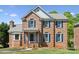 Beautiful brick two-story home with blue shutters and well-manicured front lawn in a sought-after neighborhood at 4161 Deerfield Dr, Concord, NC 28027