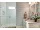 Stylish bathroom with a glass-enclosed shower, marble vanity, and decorative wallpaper at 421 Mcdonald Ave, Charlotte, NC 28203