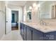 Bright bathroom featuring double sink vanity, large mirror, and a stylish tile floor at 421 Mcdonald Ave, Charlotte, NC 28203