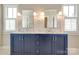 Bright bathroom featuring double sink vanity, a large mirror, and natural light at 421 Mcdonald Ave, Charlotte, NC 28203